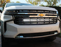 white 2021 2022 2023 2024 Chevrolet Suburban with one led white light bars behind the grille for off roading