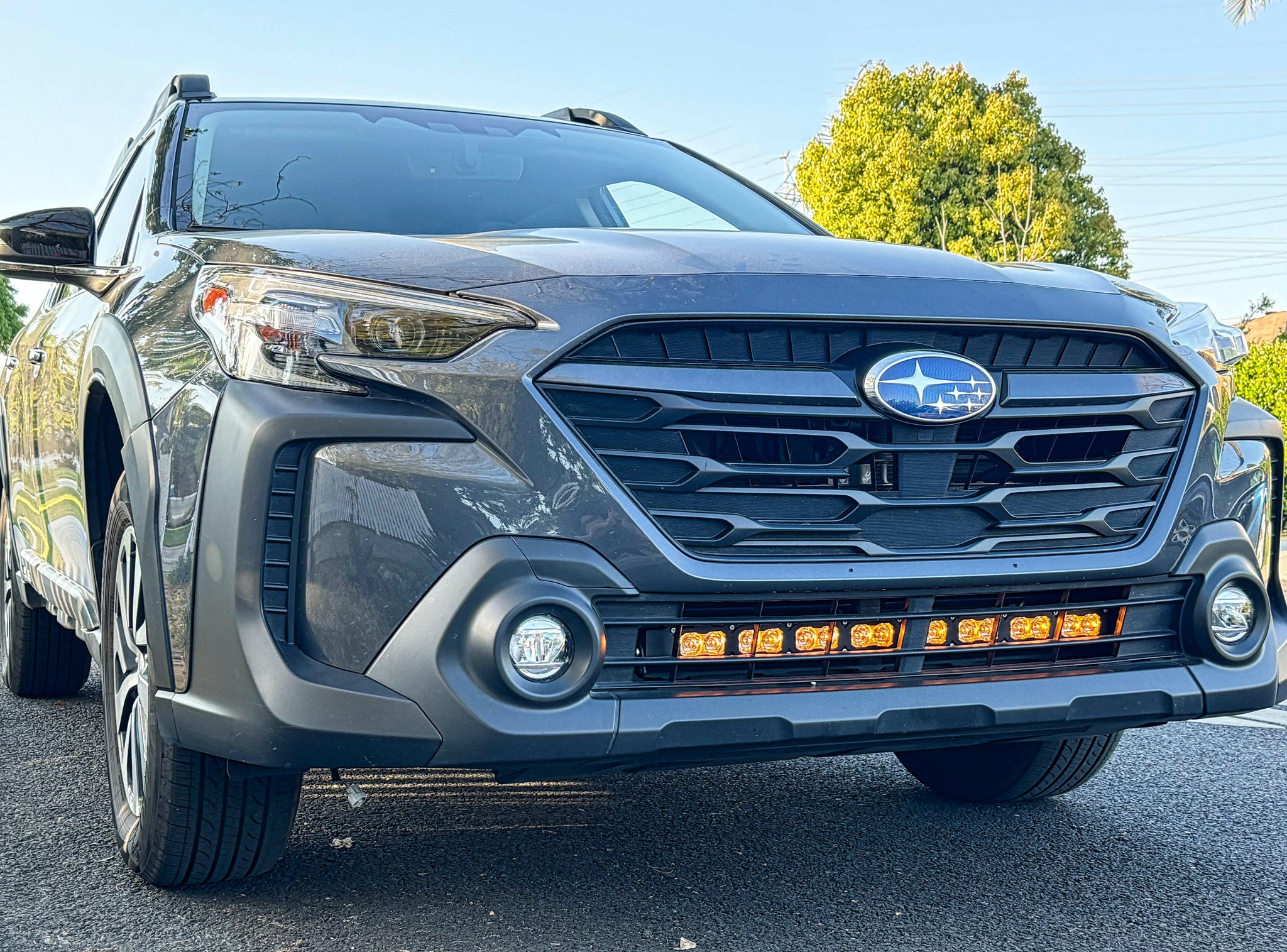 grey subaru outback with amber daytime running lights led light bar off roading