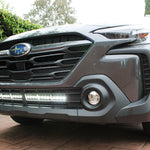 grey subaru outback with white led light bar off roading