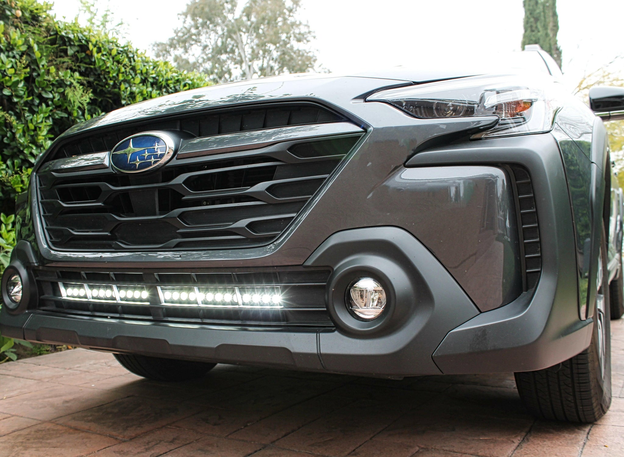 grey subaru outback with white led light bar off roading