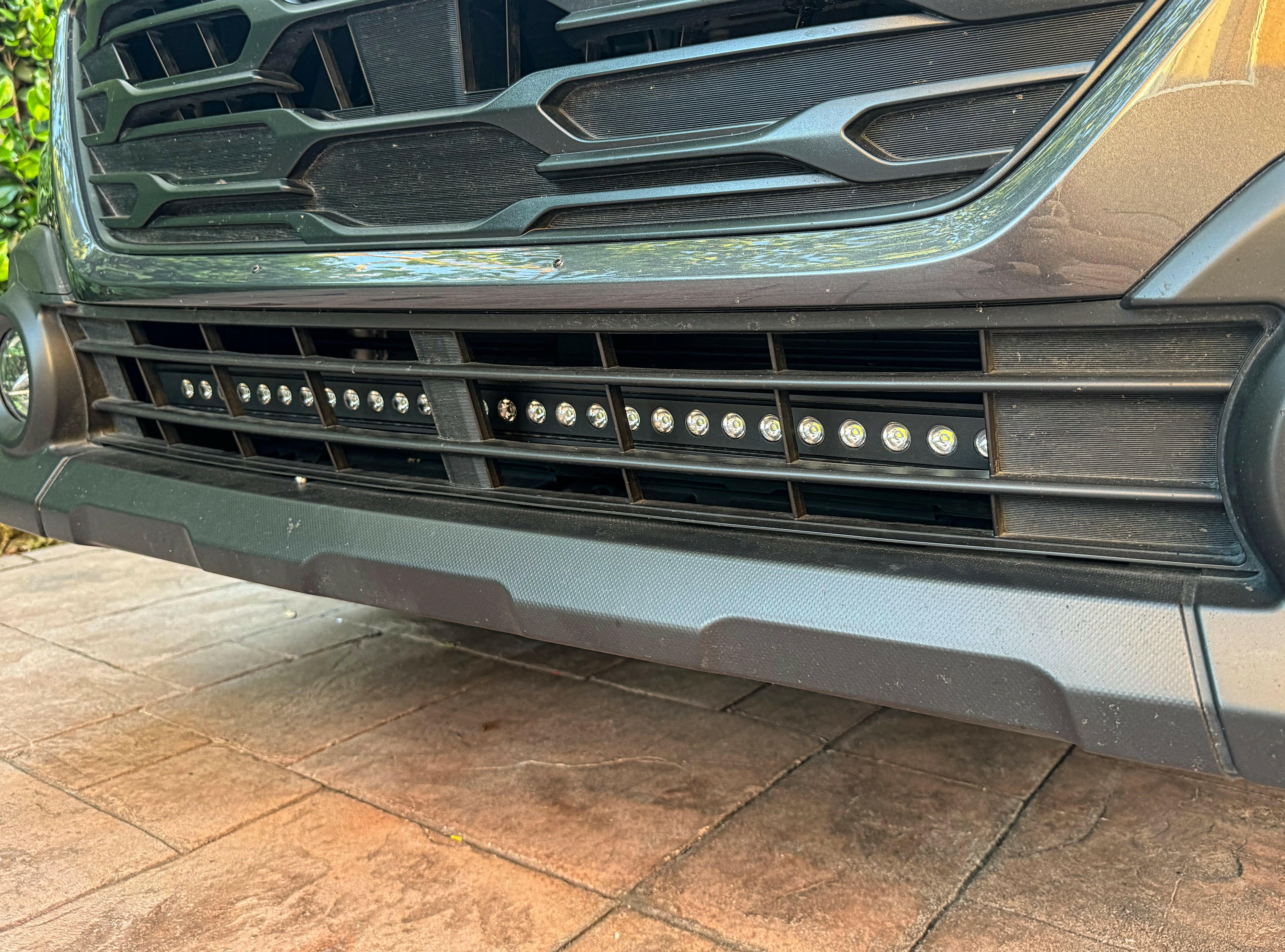 grey subaru outback with led light bar off roading
