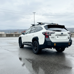 Subaru Outback reverse light kit installed on white 2020-2024 Outback SUV in wet parking lot, rear view showcasing LED pods