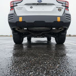 Subaru Outback reverse light kit installed on 2020-2024 Subaru Outback rear bumper in wet parking lot