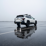 Subaru Outback reverse light kit on 2020-2024 Outback showing bright LED reverse pods in rainy parking lot