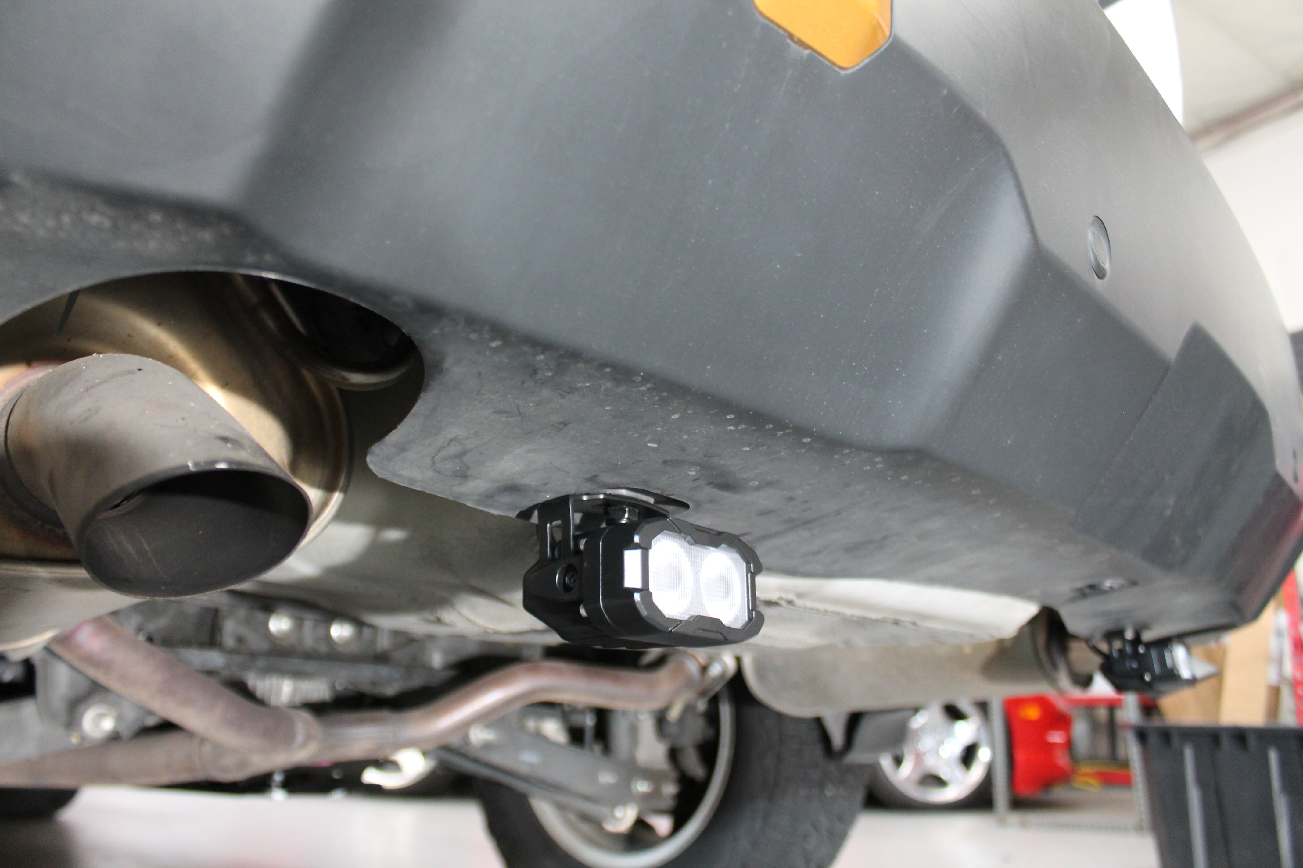 Subaru Outback reverse light kit installed under rear bumper, dual white LED pods for 2020-2024 Outback models