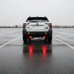 Subaru Outback reverse light kit on 2020-2024 Outback with bright LED pods and red backlight illuminated in wet parking lot