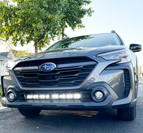 grey subaru outback with white led light bar off roading