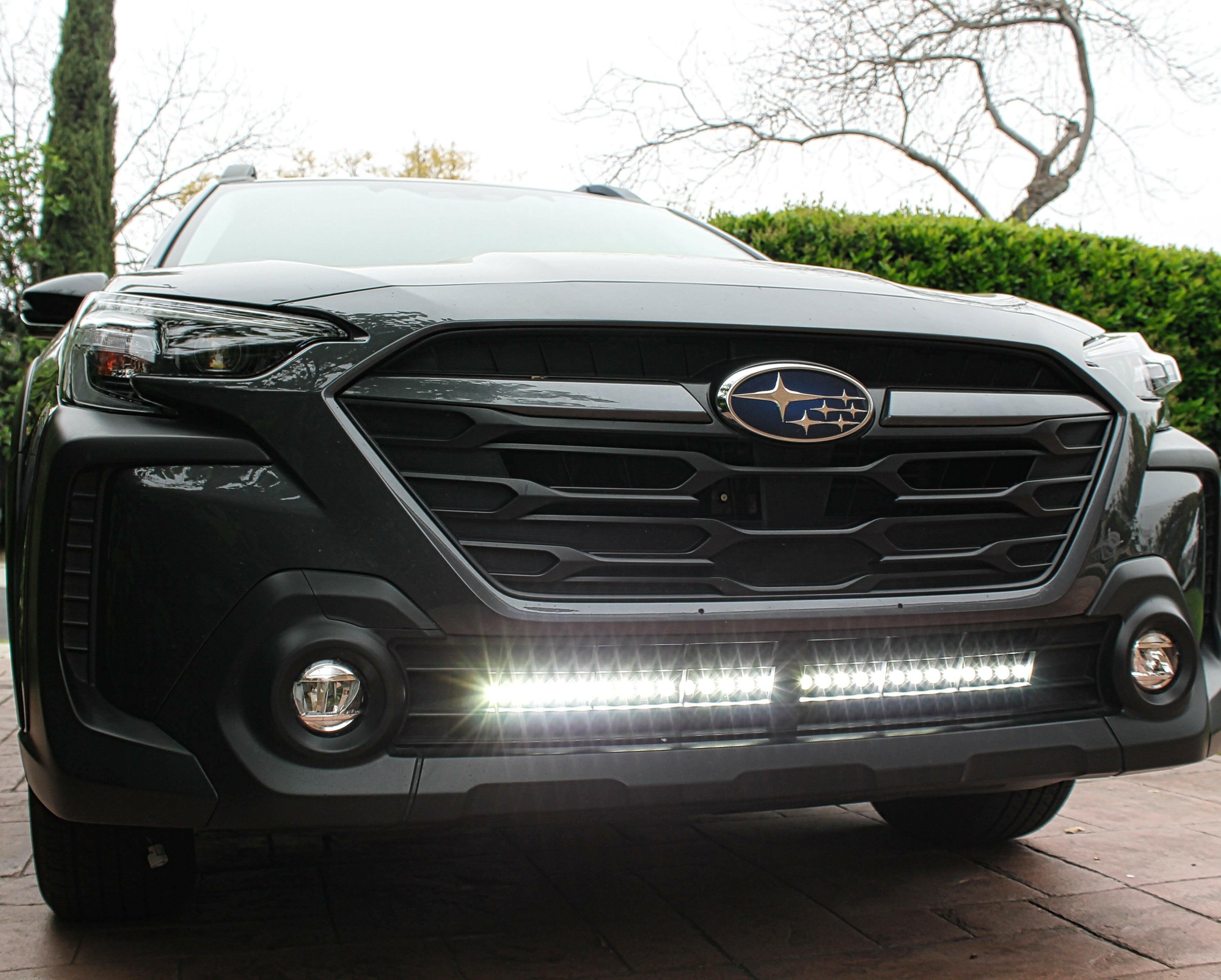 grey subaru outback with led light bar off roading