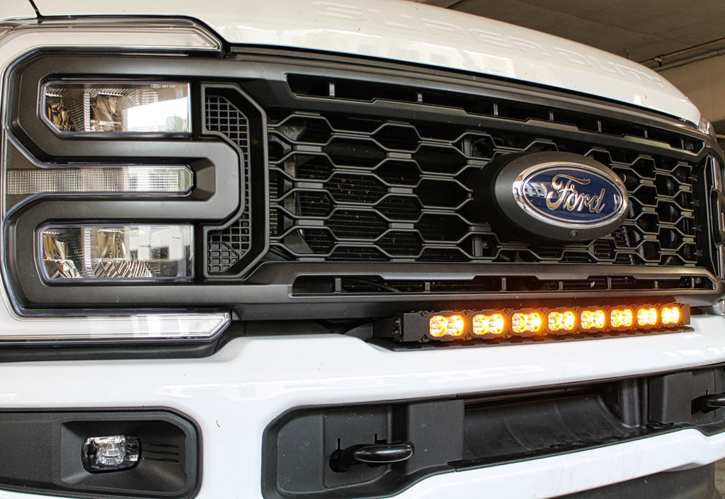 white 2023 2024 Ford F250/350/450 Superduty Single 30in curved LED light bar with amber daytime running lights on