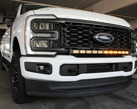 curved amber daytime running lights LED light bar installed on the bumper of white 2023 2024 ford superduty with 40in curved LED light bar on top of bumper white 2024 ford superduty 