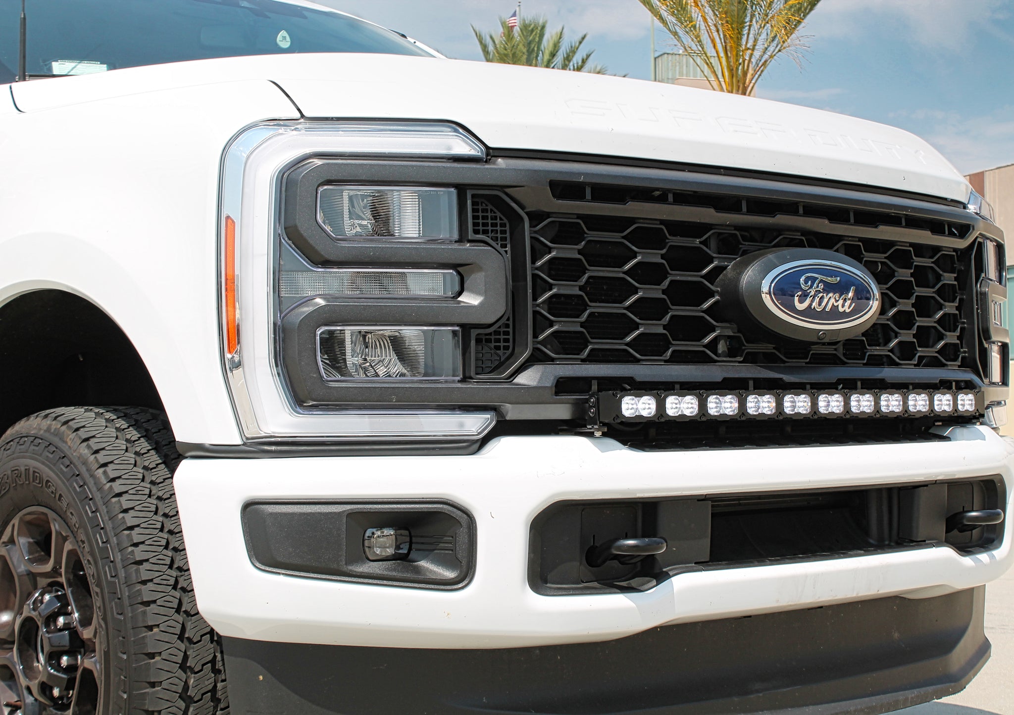 white 2023 2024 ford superduty with 40in curved LED light bar on top of bumper 