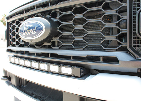 sleek design, curved LED light bar, up close view white LED light bar on a white 2023 ford superduty 