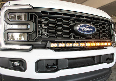 white 2023 2024 ford superduty with 40in curved LED light bar on top of bumper , amber day time running lights are on