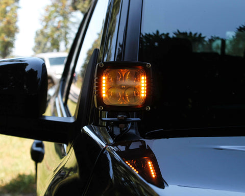 upclose ditch light on new black 2024 toyota tacoma amber light hood mount