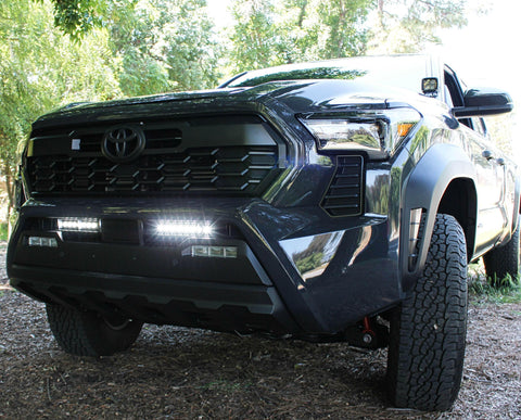 black 2024 toyota tacoma white led iight bars behind grille and ditch lights