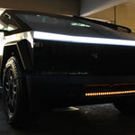 black tesla cybertruck with amber curved LED light bar in the bumper