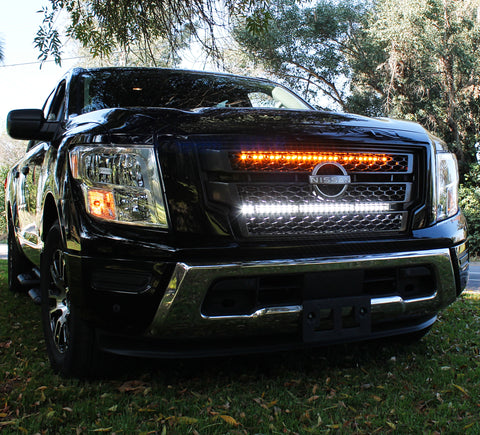 black nissan titan with off road led light bars behind the grille