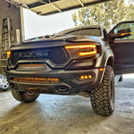 Black 2019-2024 RAM 1500 TRX with fog light kit amber DRL lit in the front bumper, front corner view
