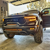 Black 2019-2024 RAM 1500 TRX with fog light kit amber DRL lit in the front bumper, front corner view