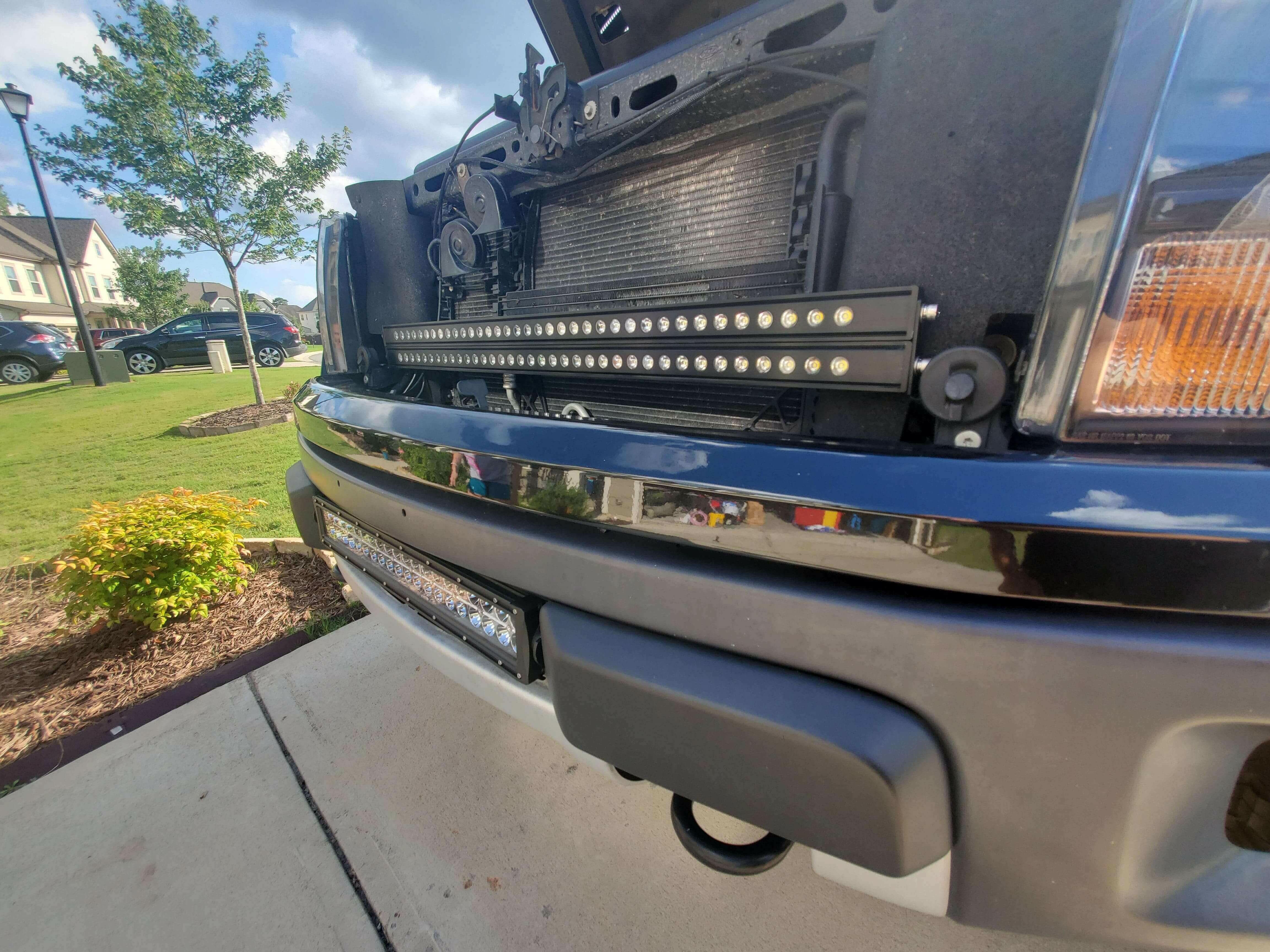 2010-2014 Ford Raptor Gen 1 Light Bars mounted behind front grille on bumper, bolt-on dual 40s LED installation view