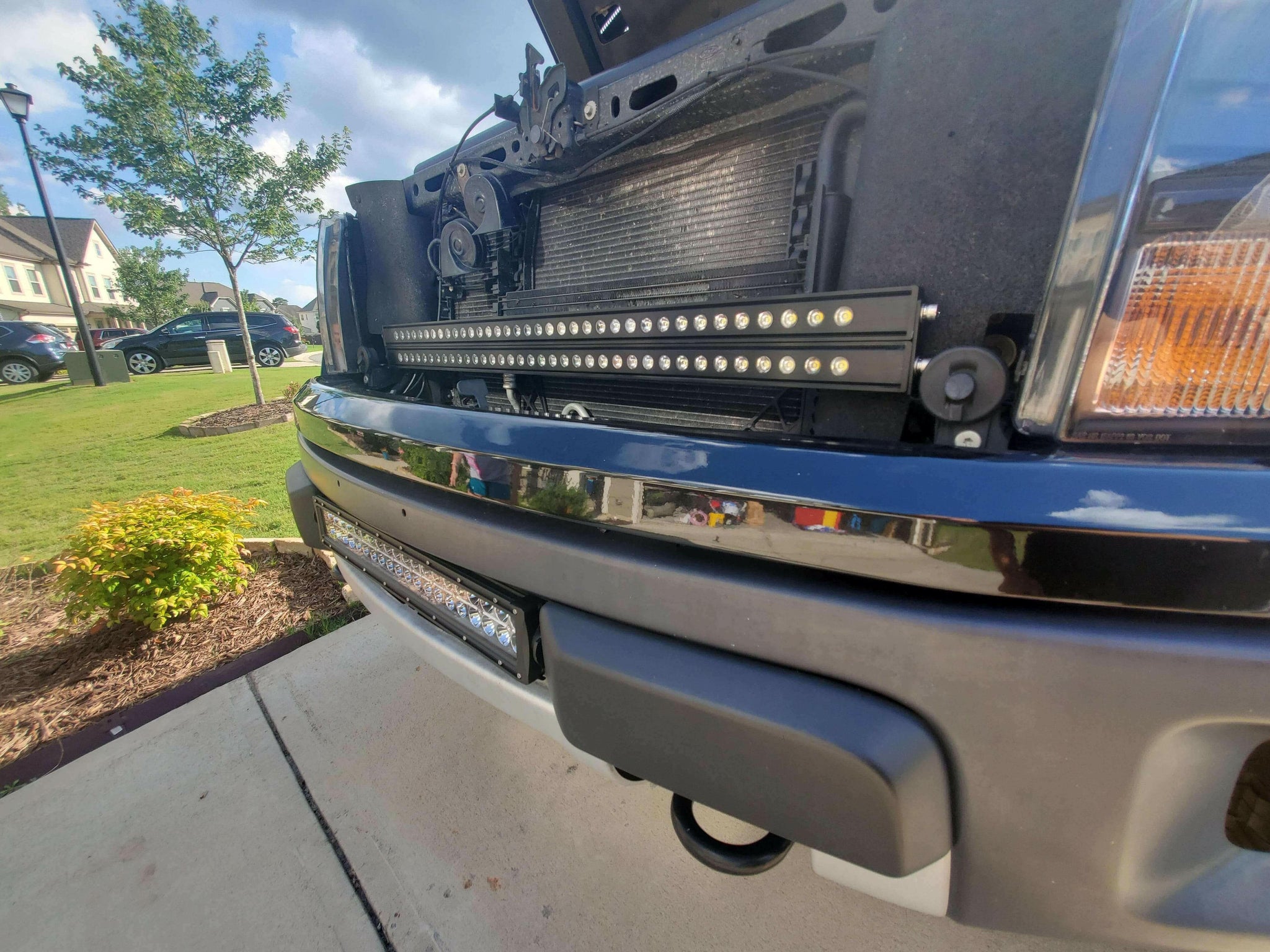 2010-2014 Ford Raptor Gen 1 Light Bars mounted behind front grille on bumper, bolt-on dual 40s LED installation view