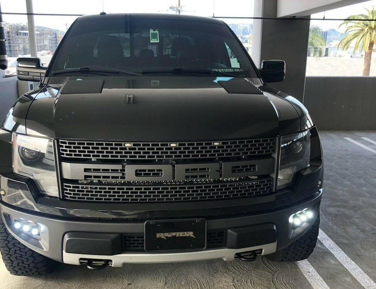 2010-2014 Ford Raptor Gen 1 fog light kit installed in front bumper showing dual function fog pods with white and amber DRL