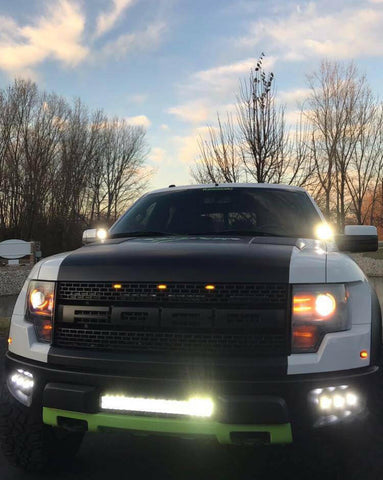 2010-2014 Ford Raptor Gen 1 Dual Function Fog Light Kit installed with bright Ford Raptor Gen 1 fog light pods at dusk