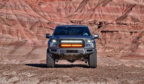 gray ford raptor generation 2 in the mountains with 2 40in behind the grille light bars color white and amber 