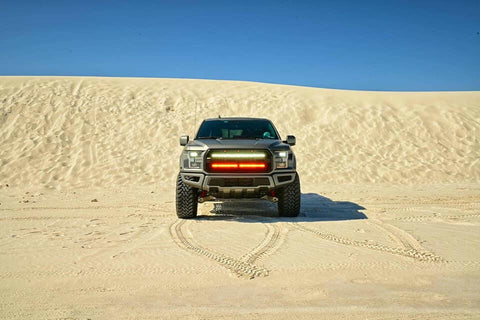 gray ford raptor generation 2 in the dessert with 2 40in behind the grille light bars color white and amber 