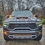 RAM Rebel fog light kit on 2019-2024 RAM 1500 Rebel front view with LED fog lights and grille lighting in rainy weather