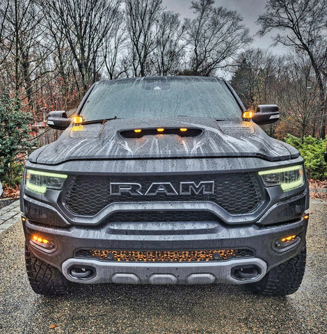 RAM Rebel fog light kit on 2019-2024 RAM 1500 Rebel front view with LED fog lights and grille lighting in rainy weather