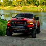 RAM Rebel fog light kit on red RAM 1500 parked by riverside, showcasing upgraded RAM Rebel fog light