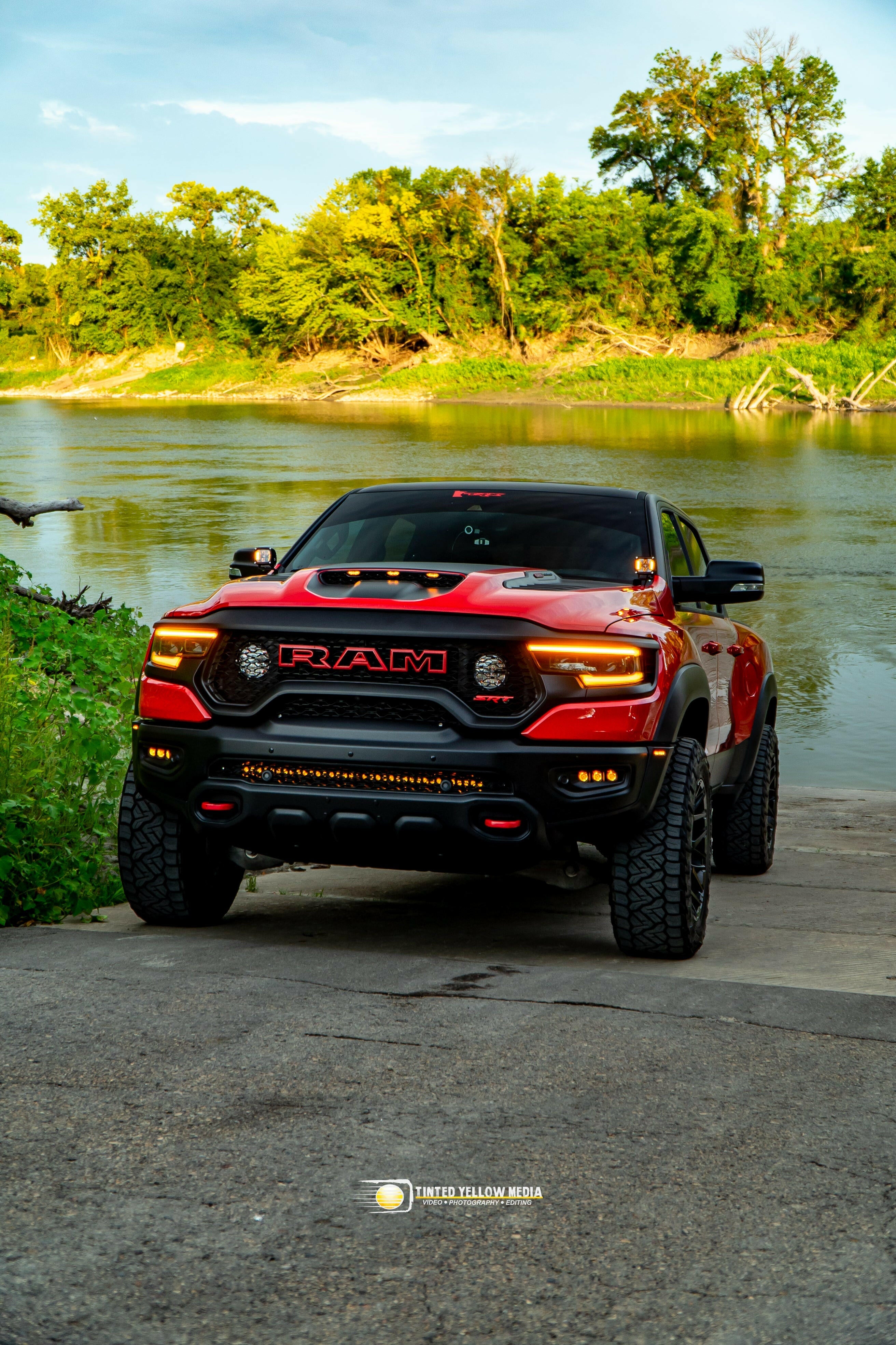 RAM Rebel fog light kit on red RAM 1500 parked by riverside, showcasing upgraded RAM Rebel fog light