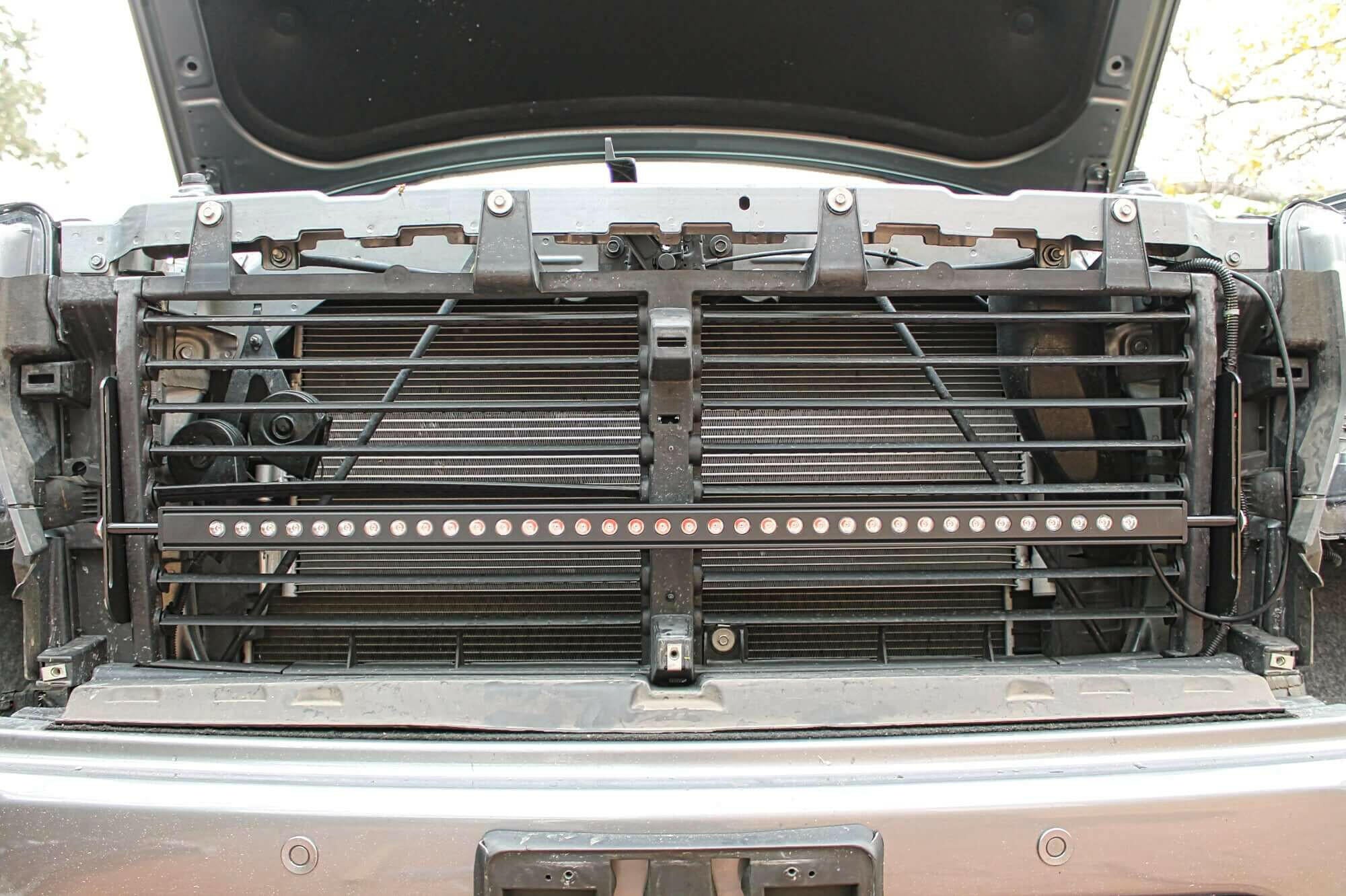 2019 2020 2021 2022 2023 gray GMC Sierra 1500 with one 40in Light Bar behind the grille and hood up