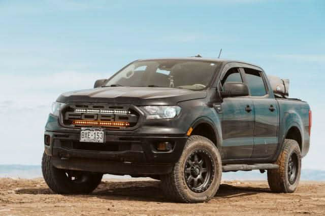 black 2019 2020 2021 2022 ford ranger off roading with 2 30in light bars behind the grille color