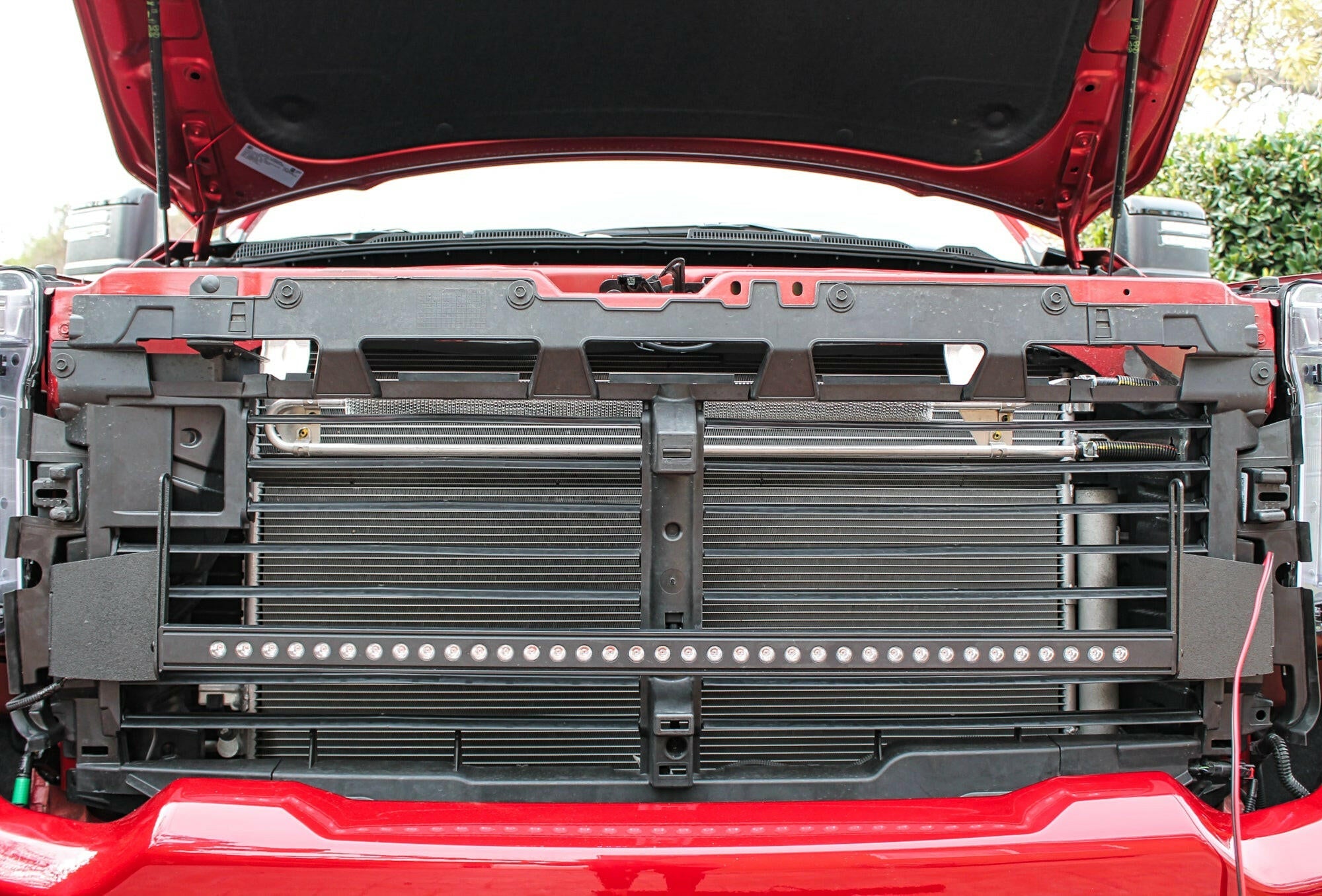 2020 2021 2022 2023 red GMC Sierra 2500 and 3500HD two 40in Light Bars behind the grille with hood up