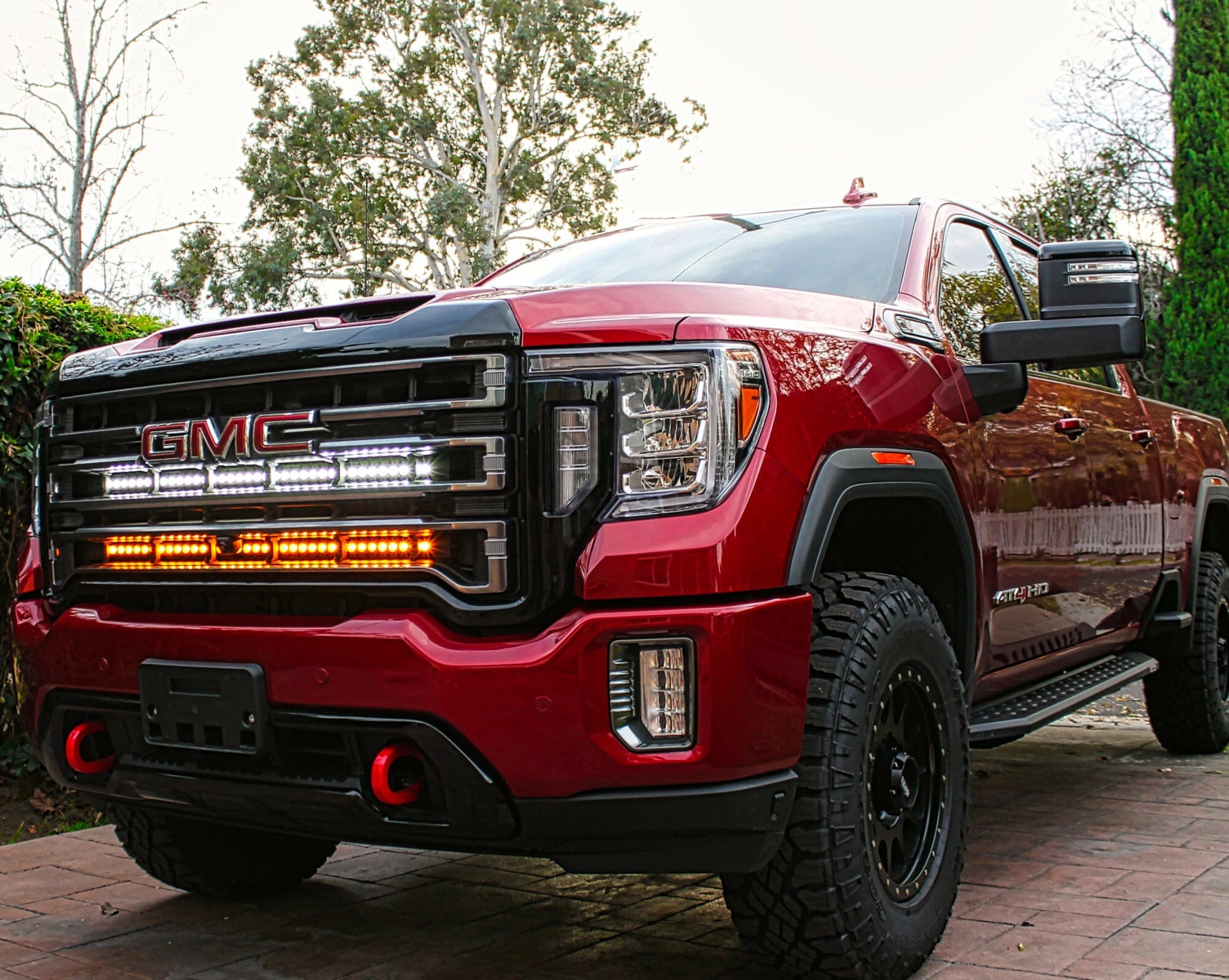 2020 2021 2022 2023 red GMC Sierra 2500 and 3500HD two 40in Light Bars behind the grille color amber and white 
