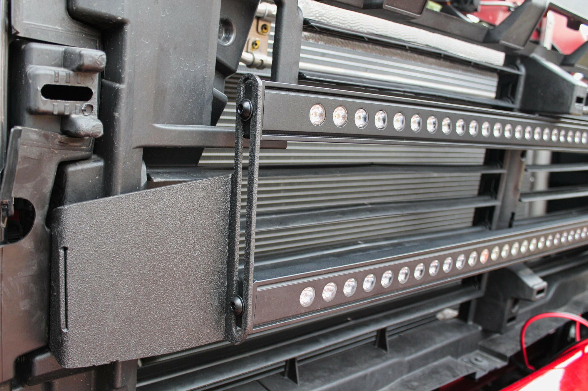 2020 2021 2022 2023 red GMC Sierra 2500 and 3500HD two 40in Light Bars behind the grille showing black metal bracket
