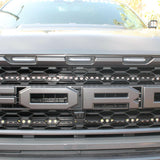 u[ close view of 2021 22021 2022 2023 ford raptor generation 3 grille with off roading light bars behind