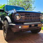 Black Jeep Gladiator Rubicon off-road vehicle with rugged tires, daytime running lights, and bold front grille