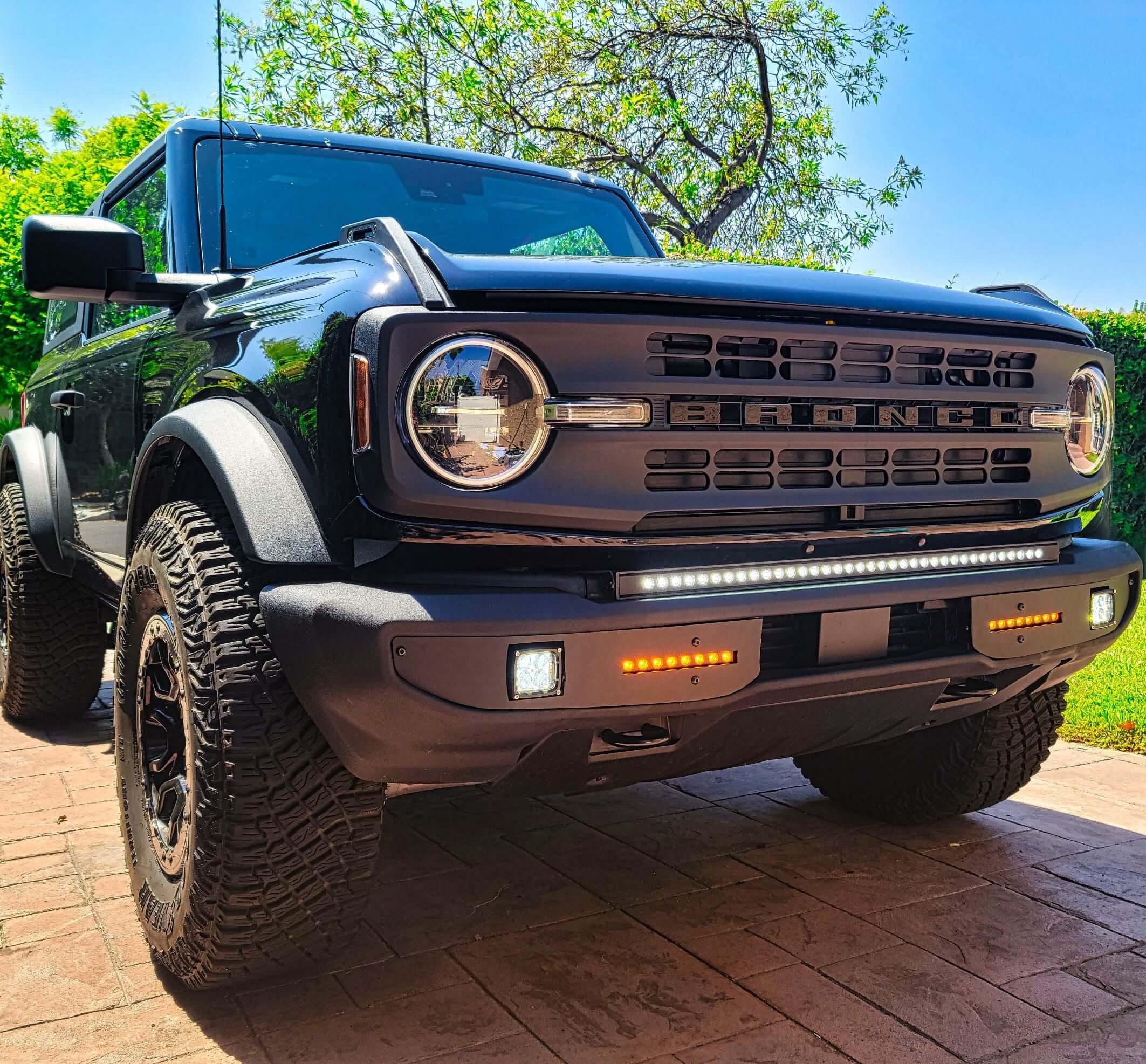 Black Jeep Gladiator Rubicon off-road vehicle with rugged tires, daytime running lights, and bold front grille