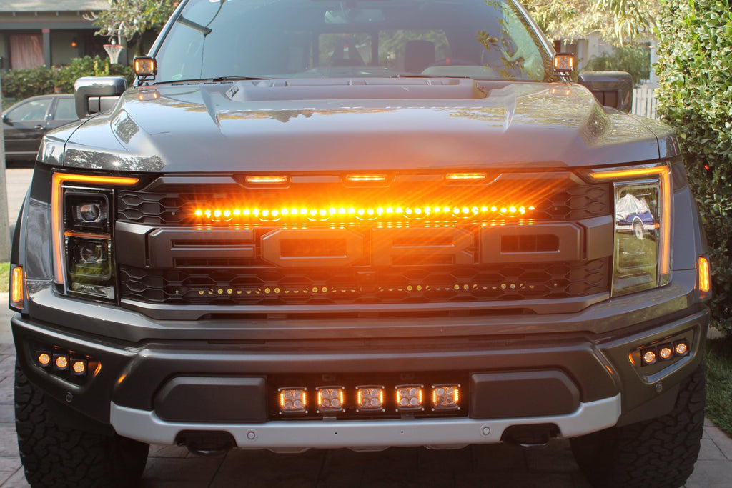 2021 2022 2023 ford raptor generation 3 with amber light bar behind the grille 