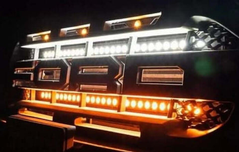 White pickup truck with rugged front grille and LED light bar, close-up front view on driveway