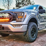 gray 2021 2022 2023 ford f150 with 2 white 30in light bars behind the grille color white and amber