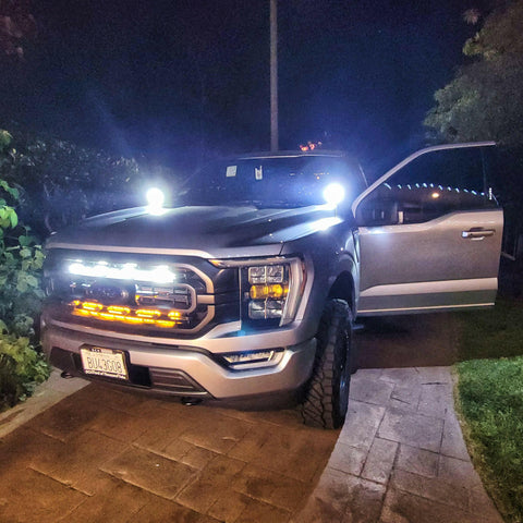 gray 2021 2022 2023 ford f150 with behind grille off road light bars and white ditch lights