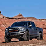 gray ford raptor generation 2 in the mountains with 2 40in behind the grille light bars color white and amber 