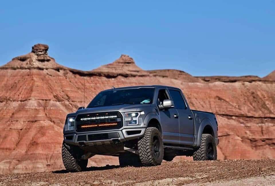gray ford raptor generation 2 in the mountains with 2 40in behind the grille light bars color white and amber 