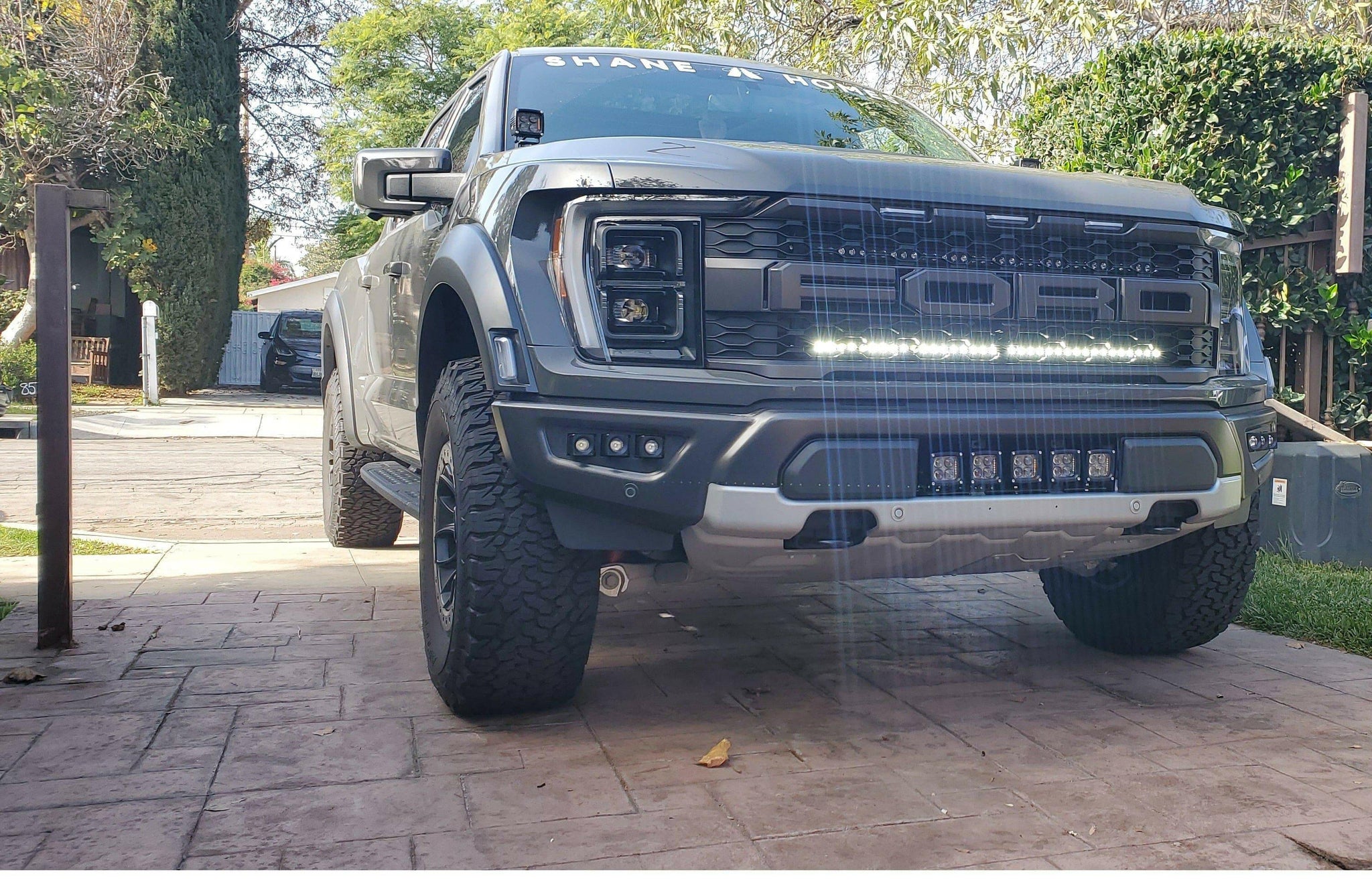 gray 2021 2022 2023 ford raptor generation 3 with one white light bar behind the grille 