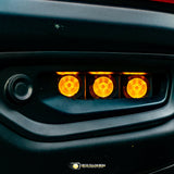 Close-up of RAM Rebel fog light kit 2019-2024 with triple amber LED RAM Rebel fog light illuminated