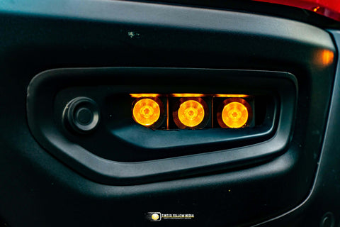 Close-up of RAM Rebel fog light kit 2019-2024 with triple amber LED RAM Rebel fog light illuminated